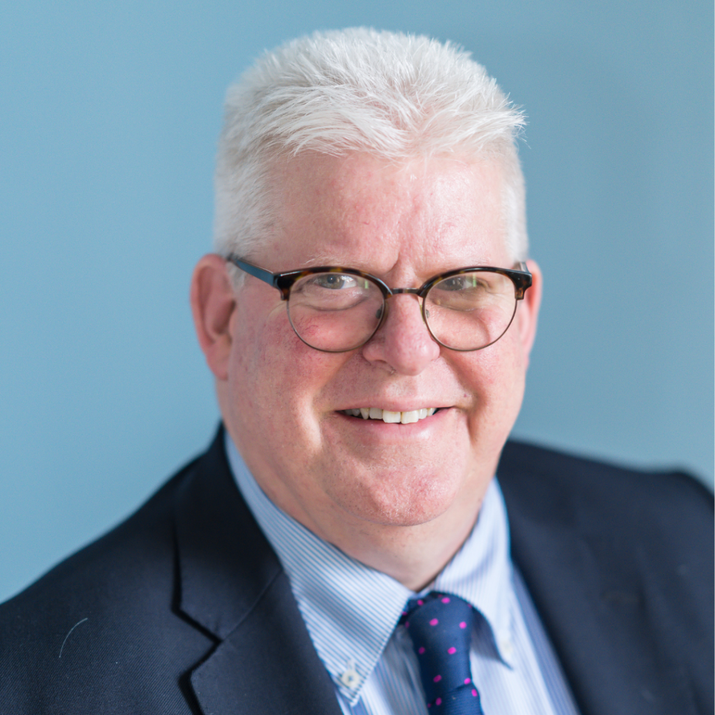 Image of Healthwatch Norfolk Chief Executive, Alex Stewart with light blue background