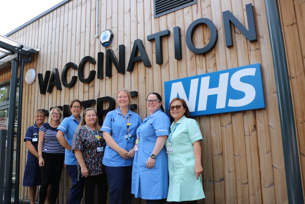 image shows staff outside the vaccination centre at Kings Lynn