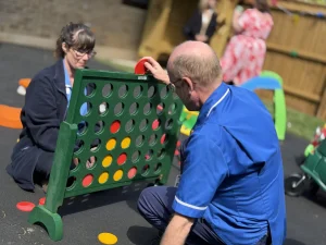 Picture of staff members playing a game in the new garden 